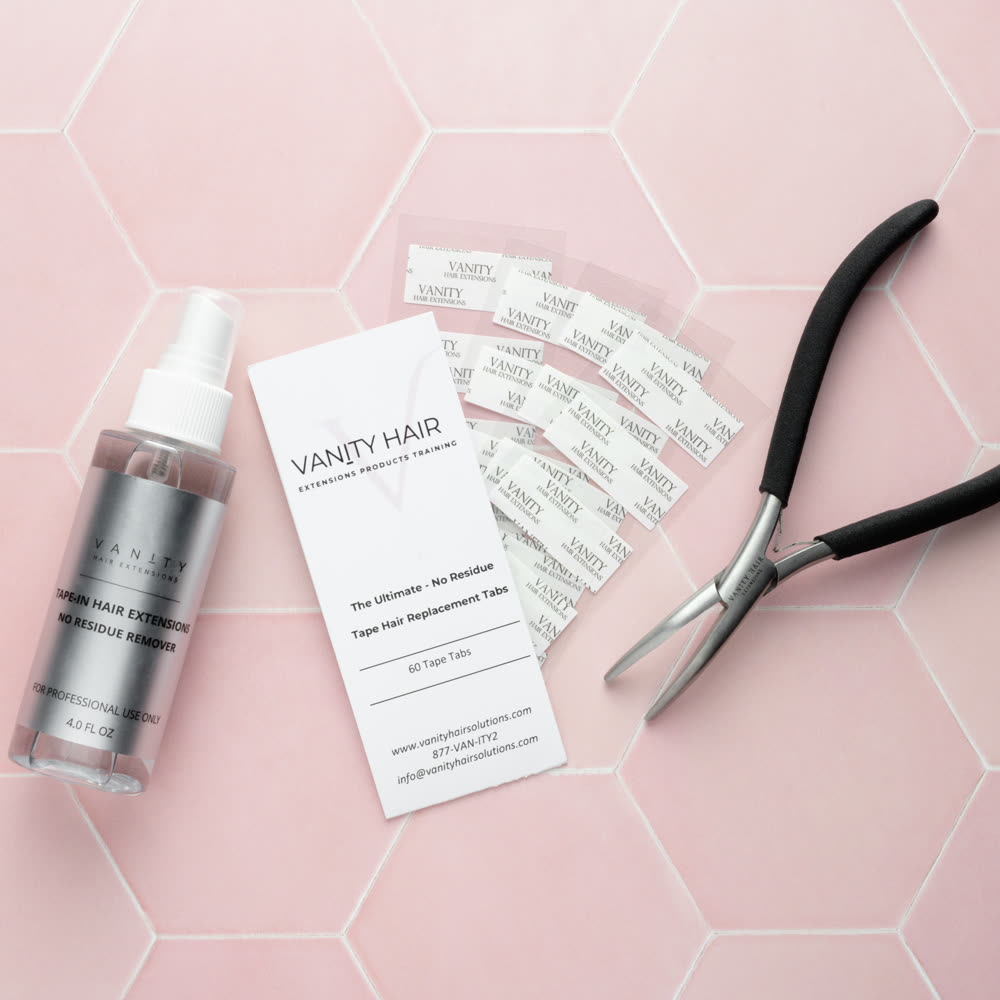 The Removal Kit — remover, tab card, tabs and application pliers on pink hexagon tile