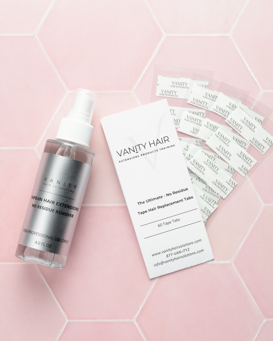 Vanity no-residue remover, replacement tab card and application pliers on pink hexagon tile